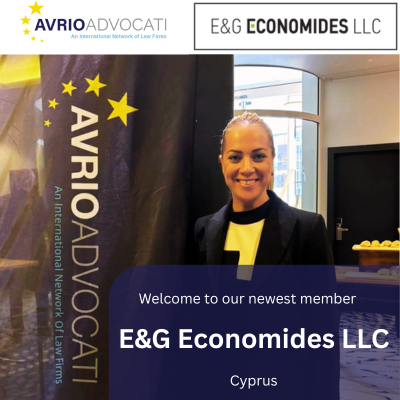 Virginia Adamidou from E&G Economides standing beside Avrio Advocati branding